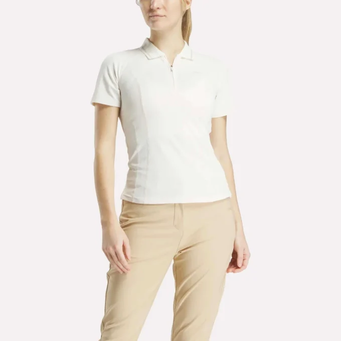 Polo de golf ajustado con cremallera y manga corta para mujer Polo de golf ajustado con cremallera y manga corta para mujer