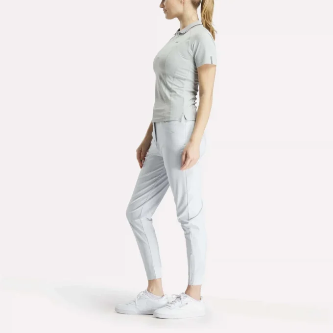 Polo de golf ajustado con cremallera y manga corta para mujer Polo de golf ajustado con cremallera y manga corta para mujer