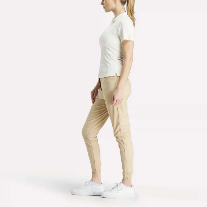 Polo de golf ajustado con cremallera y manga corta para mujer Polo de golf ajustado con cremallera y manga corta para mujer